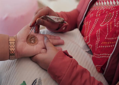 A Slow Motion Shot of Applying Mehndi on Bride's hand at her Indian Wedding in India