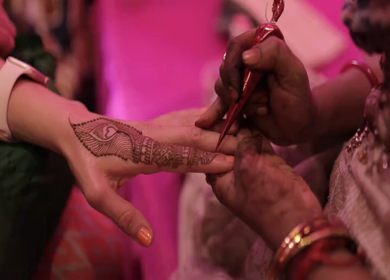 A Slow Motion Shot of Applying Mehndi on Bride's hand at her Indian Wedding in India