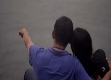 A Shot of Couple Enjoying Monsoon Rain by the Lakeside