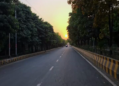 A Shot of Driving on Tree Lined Road at Sunset in Delhi India