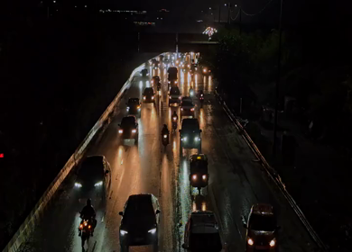 A Shot of Night Traffic on Wet Road in Delhi India with Headlights