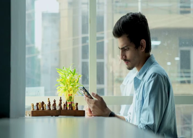 A Shot of an Indian Boy doing work discussion over a phone call in office