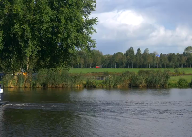 20th March 2026 : A Slow Motion Shot Boat Cruising on Canal in Amsterdam Netherlands with Dutch Flag