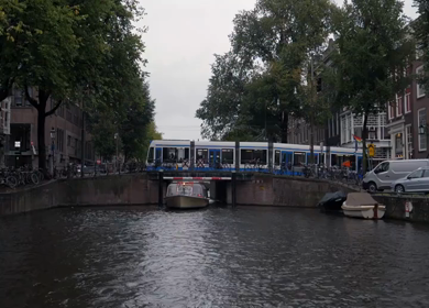 A Slow Motion Shot of Boat and Bridge from boat in Canal Amsterdam