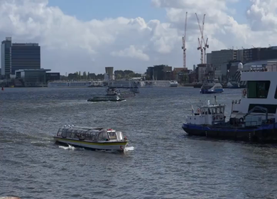 20th March 2026 : A Slow Motion Shot of Boat and Bridge from boat in Canal Amsterdam
