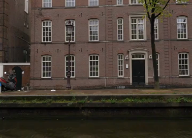 20th March 2026 : A Slow Motion Shot of Boat and Bridge from boat in Canal Amsterdam