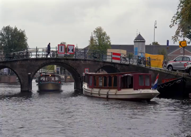 20th March 2026 : A Slow Motion Shot of Boat and Bridge from boat in Canal Amsterdam