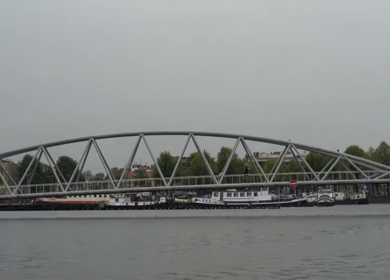 A Slow Motion Shot of Boat and Bridge from boat in Canal Amsterdam
