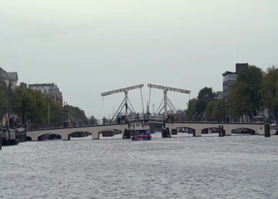 20th March 2026 : A Slow Motion Shot of Boat and Bridge from boat in Canal Amsterdam