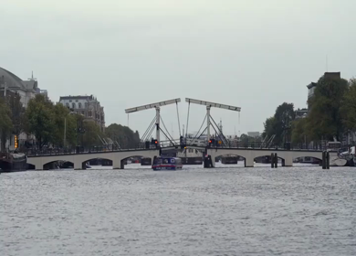 20th March 2026 : A Slow Motion Shot of Boat and Bridge from boat in Canal Amsterdam