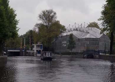 A Slow Motion Shot of Boat and Bridge from boat in Canal Amsterdam