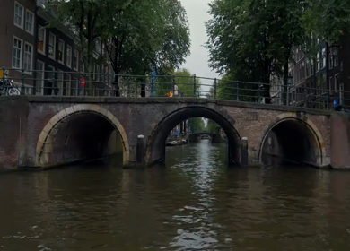 A Slow Motion Shot of Boat and Bridge from boat in Canal Amsterdam