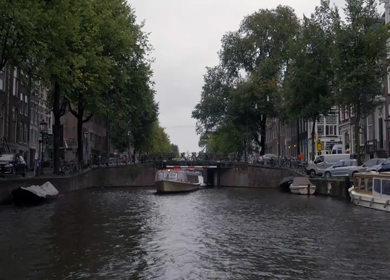A Slow Motion Shot of Boat and Bridge from boat in Canal Amsterdam