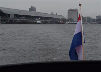 Slow Motion Shot of Amsterdam Canal Water with Dutch Flag in Amsterdam