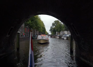Slow Motion Shot of Amsterdam Canal Water with Dutch Flag in Amsterdam