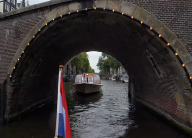 Slow Motion Shot of Amsterdam Canal Water with Dutch Flag in Amsterdam