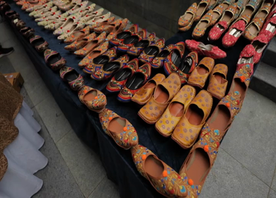 A slow motion shot of juttis at an Indian wedding in New Delhi, India