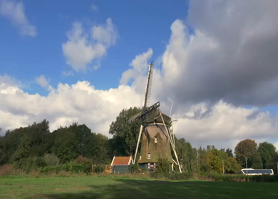 A Timelapse Shot of Traditional Dutch Windmills Under Blue Sky at Amsterdam
