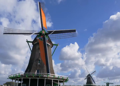 A Timelapse Shot of Traditional Dutch Windmills Under Blue Sky at Amsterdam