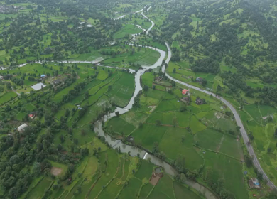 Aerial Drone View of Bhandardara Landscape with Green Valley River and Monsoon Clouds Maharashtra India