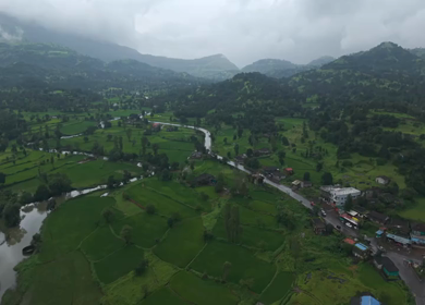 Aerial Drone View of Bhandardara Landscape with Green Valley River and Monsoon Clouds Maharashtra India