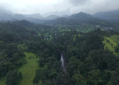 Aerial Drone View of Bhandardara Landscape with Green Valley River and Monsoon Clouds Maharashtra India