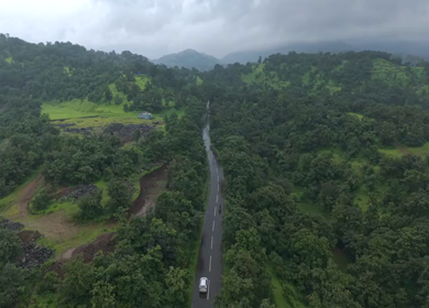 Aerial Drone View of Bhandardara Landscape with Green Valley River and Monsoon Clouds Maharashtra India