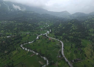 Aerial Drone View of Bhandardara Landscape with Green Valley River and Monsoon Clouds Maharashtra India