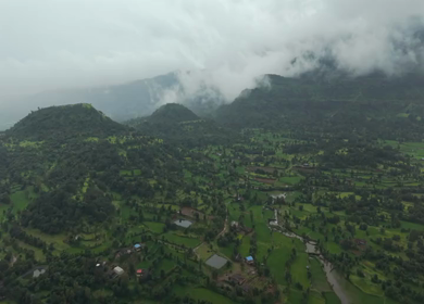 Aerial Drone View of Bhandardara Landscape with Green Valley River and Monsoon Clouds Maharashtra India