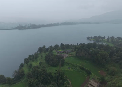 Aerial Drone View of Bhandardara Landscape with Green Valley River and Monsoon Clouds Maharashtra India