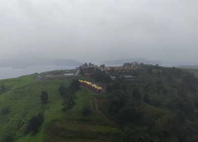 Aerial Drone View of Bhandardara Landscape with Green Valley River and Monsoon Clouds Maharashtra India
