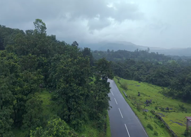 Aerial Drone View of Bhandardara Landscape with Green Valley River and Monsoon Clouds Maharashtra India