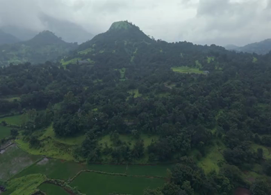 Aerial Drone View of Bhandardara Landscape with Green Valley River and Monsoon Clouds Maharashtra India