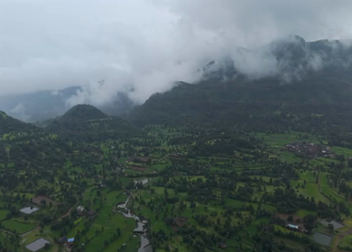 Aerial Drone View of Bhandardara Landscape with Green Valley River and Monsoon Clouds Maharashtra India