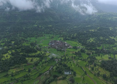 Aerial Drone View of Bhandardara Landscape with Green Valley River and Monsoon Clouds Maharashtra India