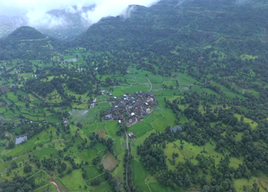Aerial Drone View of Bhandardara Landscape with Green Valley River and Monsoon Clouds Maharashtra India