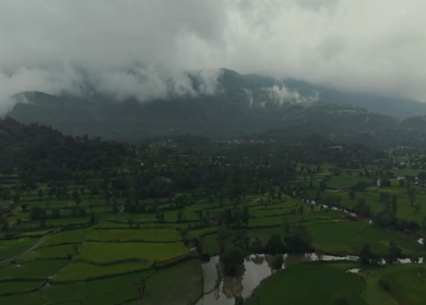 Aerial Drone View of Bhandardara Landscape with Green Valley River and Monsoon Clouds Maharashtra India