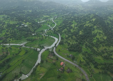 Aerial Drone View of Bhandardara Landscape with Green Valley River and Monsoon Clouds Maharashtra India