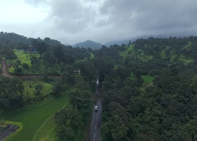 Aerial Drone View of Bhandardara Landscape with Green Valley River and Monsoon Clouds Maharashtra India