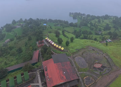 Aerial Drone View of Bhandardara Landscape with Green Valley River and Monsoon Clouds Maharashtra India
