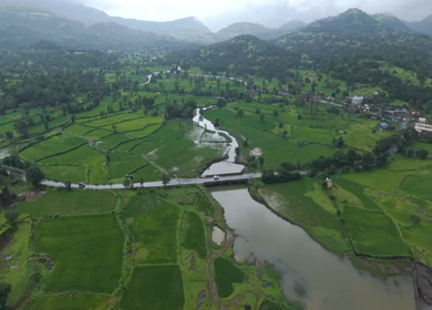 Aerial Drone View of Bhandardara Landscape with Green Valley River and Monsoon Clouds Maharashtra India