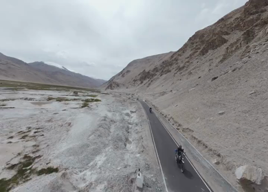 Aerial FPV View of Bikers Riding Through the Scenic Mountains of Ladakh, India