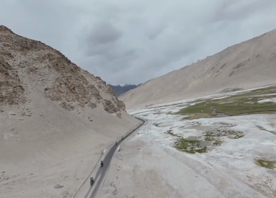 Aerial FPV View of Bikers Riding Through the Scenic Mountains of Ladakh, India