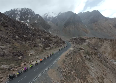 Aerial FPV View of Bikers Riding Through the Scenic Mountains of Ladakh, India