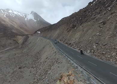 Aerial FPV View of Bikers Riding Through the Scenic Mountains of Ladakh, India
