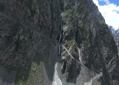 Aerial FPV View of Mountain Road and Waterfall in Ladakh, India