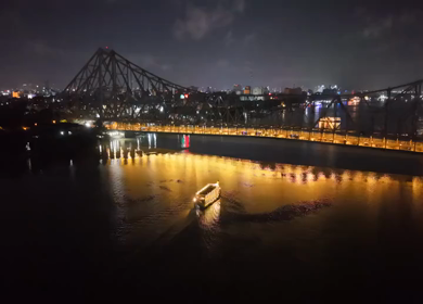 Aerial Night View of Howrah Bridge and Ferry River Kolkata, India