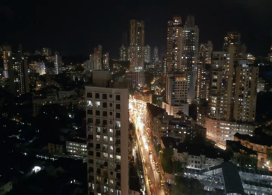 Aerial Night View of Mumbai Cityscape with Illuminated Streets and High Rise Buildings