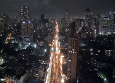 Aerial Night View of Mumbai Cityscape with Illuminated Streets and High Rise Buildings