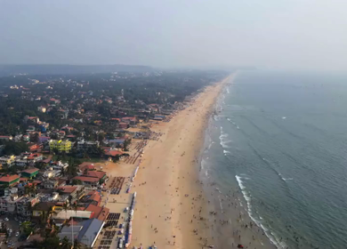 Aerial Timelapse of Baga Beach Coastline with Tourists Goa India
